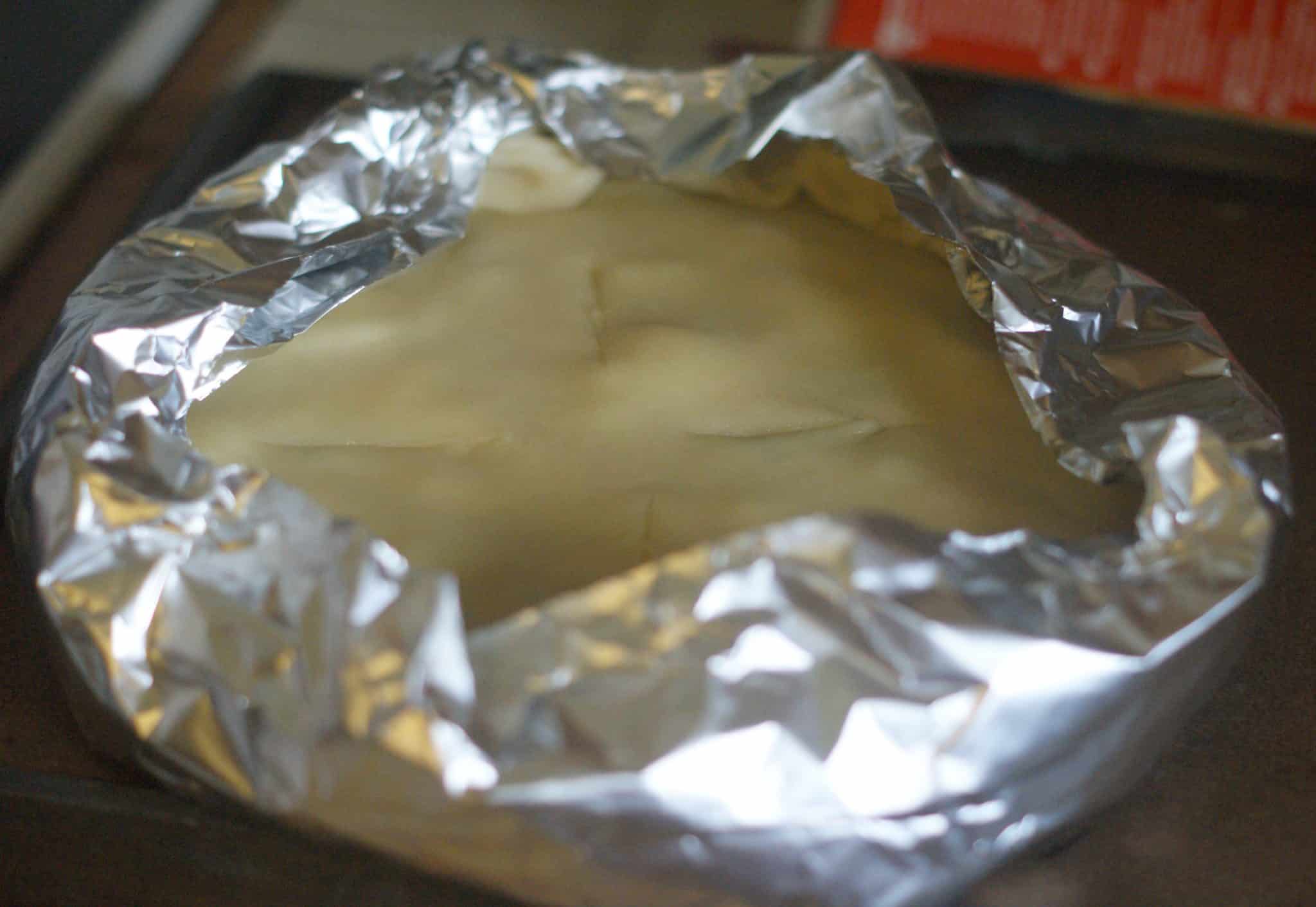 uncooked chicken pot pie with foil to prevent edges burning